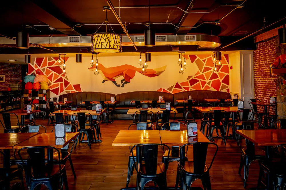 The Fox Den's fox mosaic mural and dining room